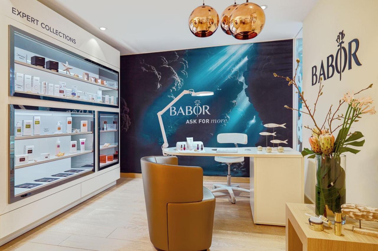 The Westin Hamburg Elbphilharmonie Hotel Exterior photo The image shows an interior shot of a beauty salon or spa that features products from the brand Babor. The space includes a stylish brown chair, a modern white desk, and a decorative display of skincare products on shelves. There is also a prominent 